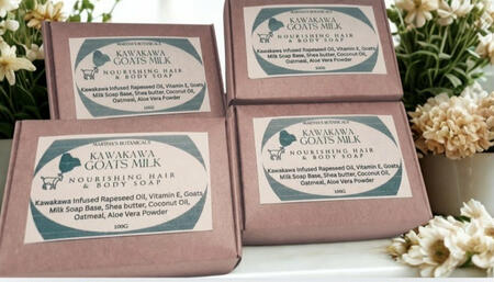 "Boxed Kawakawa Goats Milk Soap bars by Martha's Botanicals surrounded by flowers"